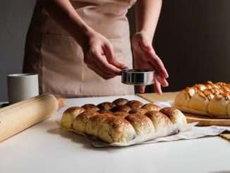 person holding stainless steel cup with brown liquid