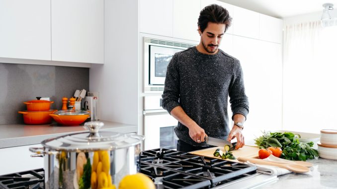 man cutting vegetables