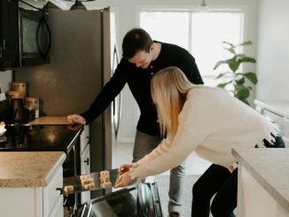 man and woman by open range oven