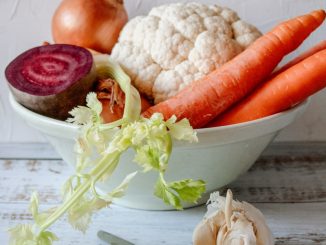 carrots and garlic in white ceramic bowl