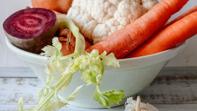 carrots and garlic in white ceramic bowl