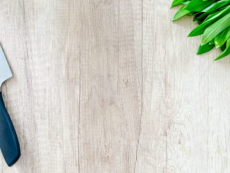 kitchen knife and green leaf vegetable on tableto