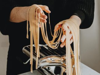 person in black sweater and black pants sitting on white chair