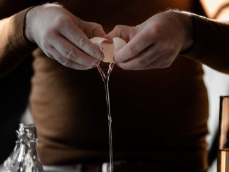 person in brown long sleeve shirt holding silver fork