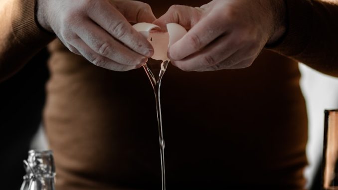 person in brown long sleeve shirt holding silver fork