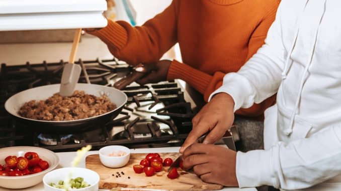 woman in orange turtleneck sweater holding brown bread