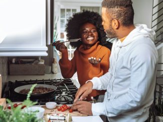 man in white dress shirt holding a woman in brown long sleeve shirt