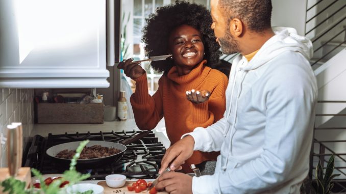 man in white dress shirt holding a woman in brown long sleeve shirt