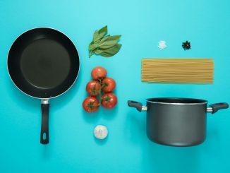 flat lay photography of frying pan beside tomatoes on blue surface