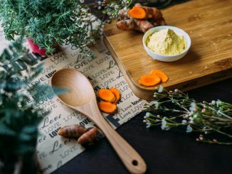 wooden ladle and chopping board with ginger during daytime