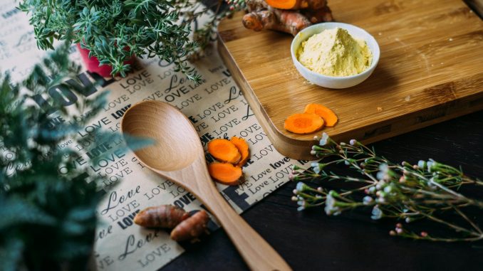 wooden ladle and chopping board with ginger during daytime