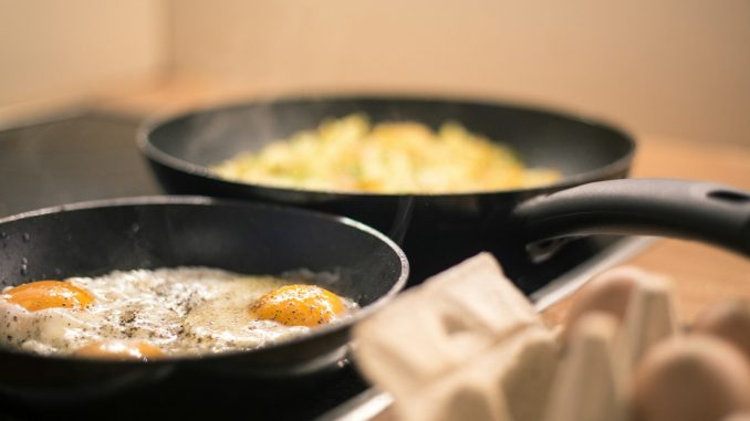 black ceramic bowl with yellow rice