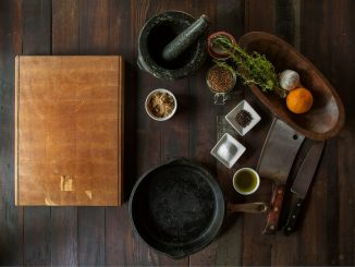 black mortar and pestle beside brown box in top view photography