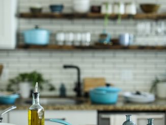 blue and white casserole near olive oil bottle on table